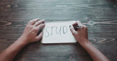 Top view, close-up hands of a man writing STUDY Video stock 260938653