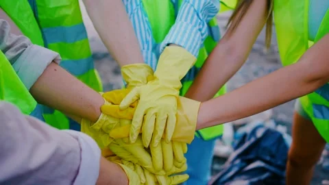 Top view close-up hands together a team of student volunteers in green vests Video stock 246827458