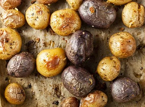 Top view close up image showing fresh oven baked potato medley with a variety Stock-Fotos