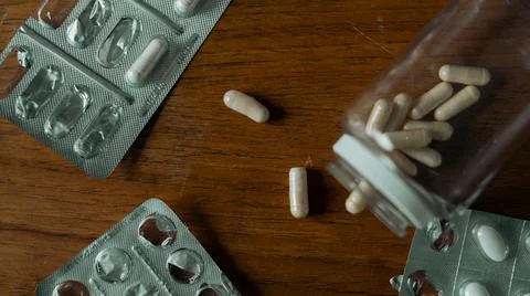 Top View Close Up of Isolated Bottle of Pills Spread Out on the Wooden Table Stock Photos