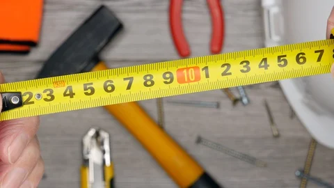 Top View Close Up Of Man's Hands With Measuring Ruler On Bokeh Wooden Background Stock Footage 127525616