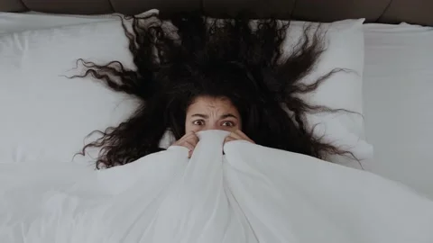 Top view close up of millennial african American girl lying in bed covered with Stock Footage 155100843