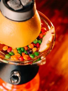 Top view close up of orange hookah bowl with skittles candies around, close u Stock Photos