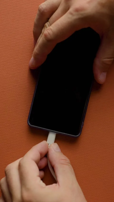 Top View Close Up of Plugging and Unplugging USB-C Cable Into Smartphone Stock Footage 343451035