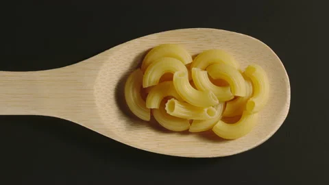 TOP VIEW: Close shot of stortini pasta appear in spoon - Stop Motion animation Stock Footage 130261964