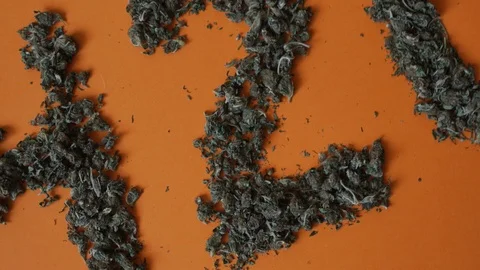 Top view close up sign 420 made from a hemp buds on red background Video stock 112306778