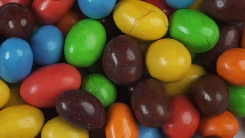 Top view close up of spinning rainbow peanut chocolate candies Stock Footage 278959014