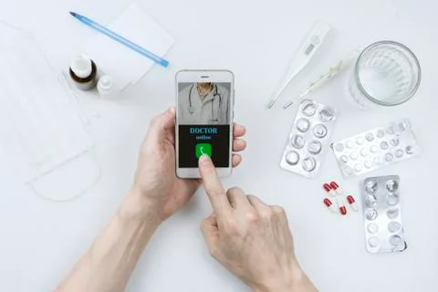 Top view - close-up of a table with pills, thermometers and water. Patient's  Stock Photos