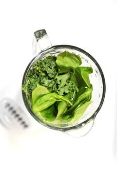 Top View Close Up of Vegetables Kale &amp; Spinach in the Glass of a Blender Stock Photos