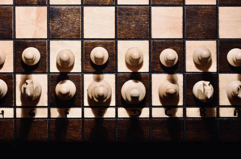 Top View Close Up of White Chess Pieces Lined Up on Wooden Chessboard with .. Stock Photos