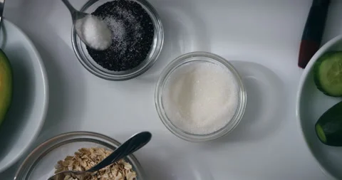 Top view close-up of woman's hand making natural organic scrub face mask, using Video stock 148781425
