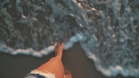 Top view close-up woman's legs in sea at sunset Stock Footage 114072564