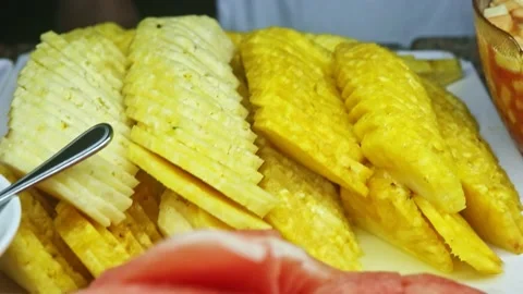 Top view closeup on cleaned ripe pineapple slices at food court assortment Stock Footage 143084366