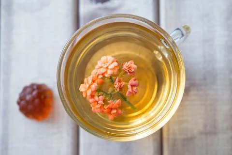 Top view closeup of cup of tea with bright flower on wooden table with Marmalade Stock Photos