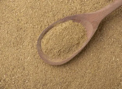 Top view, closeup of ground cumin on a wooden spoon Stock Photos