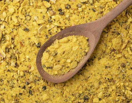 Top view, closeup of lemom pepper seasoning on a wooden spoon. Food backdrop Stock Photos