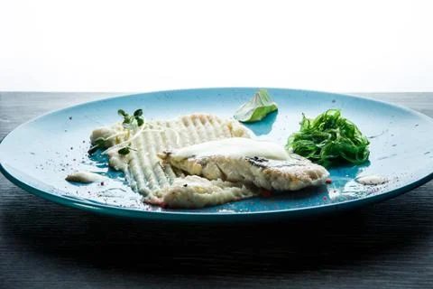 Top view closeup mashed potatoes, sea kale, and baked fish Stock Photos