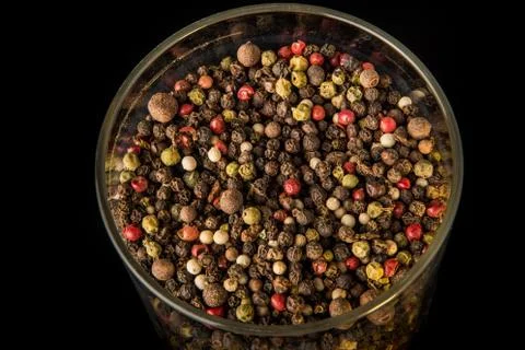 Top view closeup mix of different peppercorns in deep glass Stock Photos