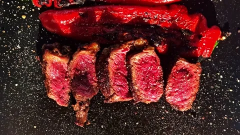 Top view closeup of sliced medium rare wagyu beef steak served with charred.. Stock Footage 337451126