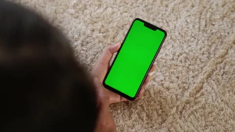 Top View, Closeup View of Mobile Phone in Girls Hands with Green Mock-up Screen Stock Footage 194800972