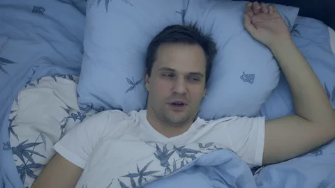 Top view. closeup. young man in bed suffering insomnia Stock Footage 128501963