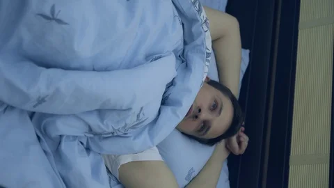 Top view. closeup. young man in bed suffering insomnia. vertically Stock Footage 129255091