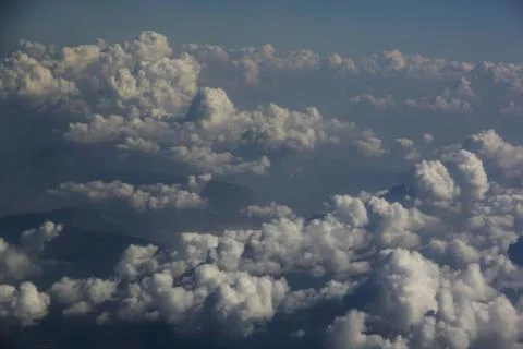 Top view of clouds from an airplane window on a sunny day Stock Photos