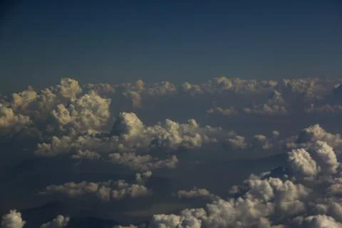Top view of clouds from an airplane window on a sunny day Stock Photos