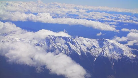 Top view of clouds and mountains from the plane Stock Footage 108064699