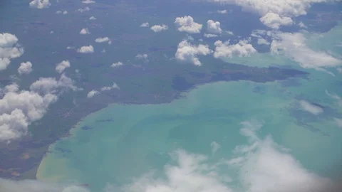 Top view of the clouds and the sea from the plane Stock-Footage 107925302