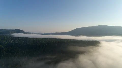 Top view of clouds, mountains, river and fog Stock Photos