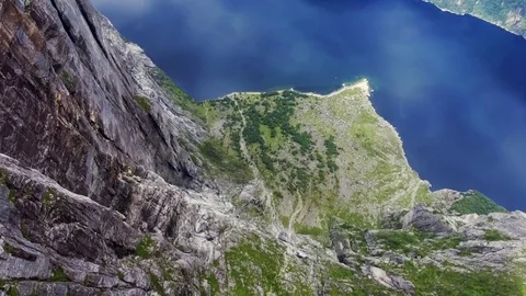 Top view of the coastline along a clean beautiful blue river, huge cliffs, green Stock Footage 80250846