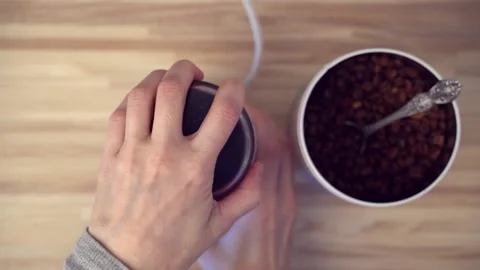 Top view of coffee beans grinding in electric grinder for preparing coffee. Stock Footage 148272210