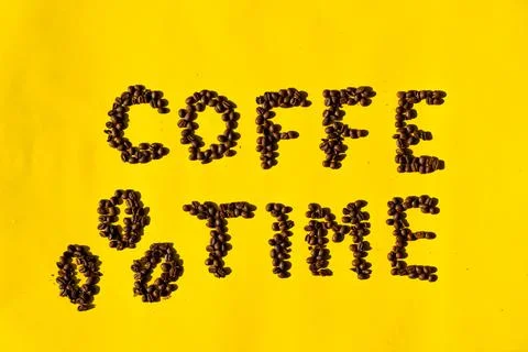 Top view of coffee beans in the shape of letters reading "coffee time" and be Stock Photos