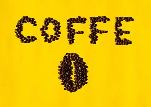 Top view of coffee beans in the shape of letters that read "coffee" and in th Stock Photos