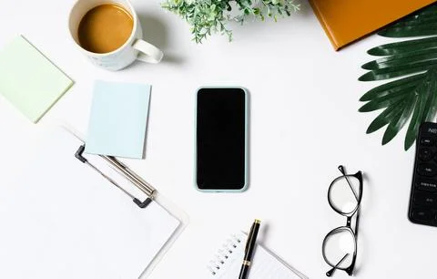 Top view of coffee, book, notebook, pen, keyboard, phone on white background Stock Photos