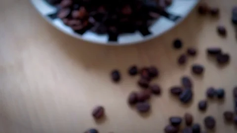 Top view of coffee cup filled with coffee beans on wooden table. Stock Footage 72338114