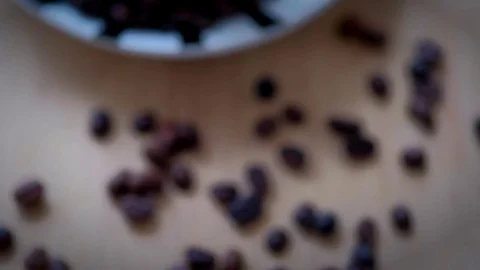 Top view of coffee cup filled with coffee beans on wooden table. Video stock 72349608