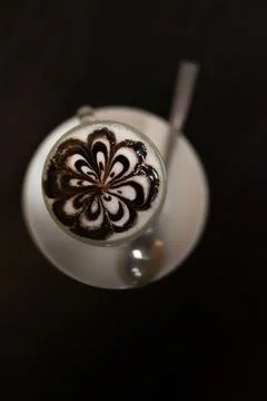 Top view of coffee cup with flower lobe pattern in reveal cup on wooden table Stock Photos