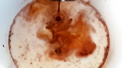 Top of view of coffee cup with milk shot in slow motion, breakfast Stock Footage 152252885