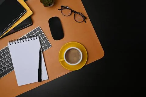 Top view coffee cup, notebook and glasses on modern workspace. Stock Photos