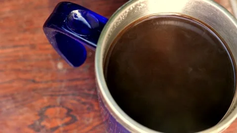 Top view of a coffee cup on the table. Steam rising intensely. An espresso cup Stock Footage 343591554