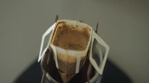 Top view of coffee dripping through filter into glass cup resting on digital Stock Footage 311053492