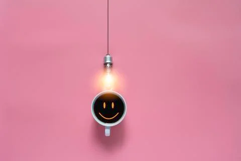Top view of coffee with light bulb on pink background and copy space for inse Stock Photos