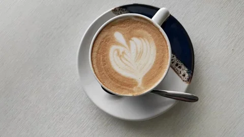 Top view of Coffee mug with heart Latte art. 動画素材 334650865
