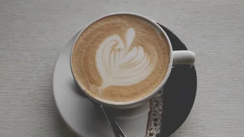 Top view of Coffee mug with heart Latte art. 動画素材 334650879