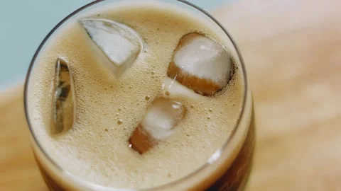 Top view of cola foam swirling around ice cubes, 4K Video stock 341120332