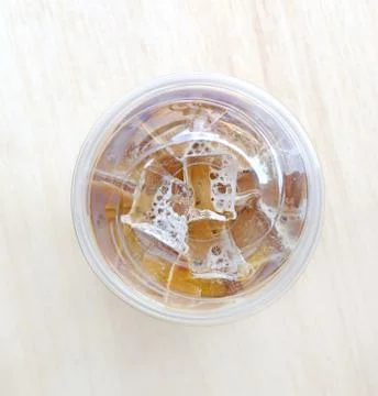 Top view cold coffee drink with ice on old wood table Stock Photos
