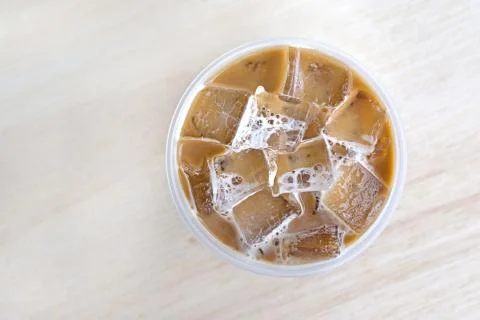 Top view cold coffee drink with ice on old wood table Stock Photos