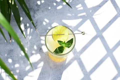 Top view of a cold refreshing melon cocktail with ice and lime slices, garnished Stock Photos